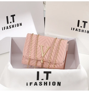 Detailed view of pink quilted leather bag with V-shaped stitching and gold chain strap