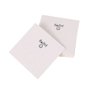 White cardboard jewelry display card with Hello smile face print and multiple earring holes
