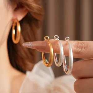 Classic gold and silver matte geometric hoop earrings with a textured brushed finish