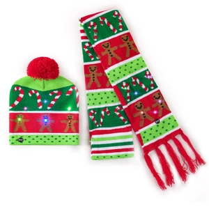 Close-up of LED glowing Christmas knitted hat and scarf set with gingerbread pattern