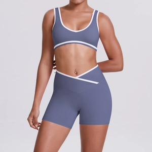 Detail of high-waisted yoga shorts with crossover waistband and white contrast trim
