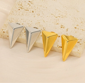 Detailed view of 3D geometric triangle stud earrings in gold and silver polished finishes