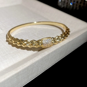Macro detail of 18K gold plated bangle featuring a sparkling zircon studded square motif