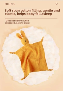 Close-up of ginger muslin cotton baby security blanket with bunny head and knotted corners