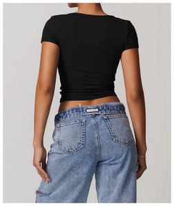 Back view of a breathable V-neck sports T-shirt paired with ripped denim jeans