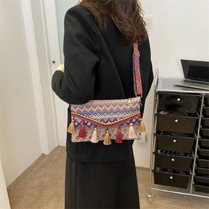 Bohemian women's crossbody bag featuring colorful jacquard patterns and tassel accents