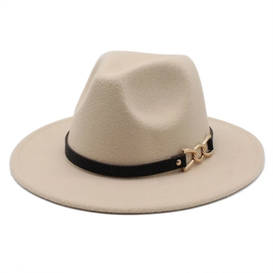 Detail of beige wool fedora featuring a black leather band and gold chain buckle