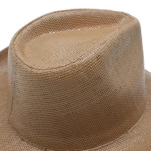 Close-up of caramel brown woven texture on a classic western style straw cowboy hat