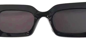 Close-up of vintage black rectangular sunglasses with glossy frame and dark lenses