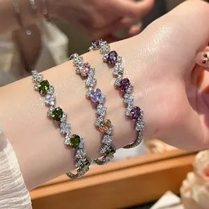 Elegant silver bracelet featuring oval zircons in green, purple, and colorful gemstones