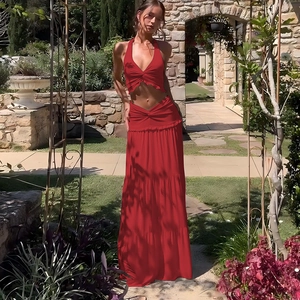 Detail of red halter crop top with front twist knot and high waist long skirt set