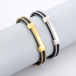 Detail of matte steel buckle and black braided leather strap on a dual-layer bracelet