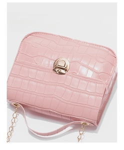 Close-up of pink crocodile texture small square bag with gold twist lock and chain strap