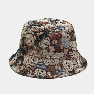 Detailed view of woven bucket hat featuring vintage cartoon teddy bear patterns in multiple colors