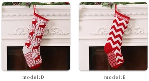 Detail of Christmas knitted stockings with reindeer and zigzag patterns on a fireplace
