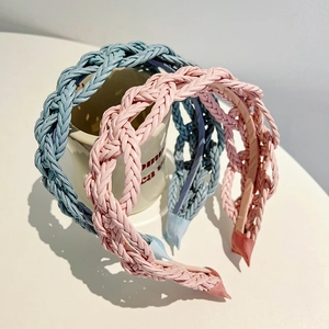 Close-up of blue and pink twisted braid leather headbands with detailed woven texture