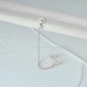 Detailed close-up of S925 sterling silver snake chain earrings with a zircon stone