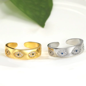 Detail of adjustable evil eye rings in gold and silver finish with pavé set crystals