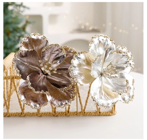 Detail of champagne and bronze artificial Christmas flowers with glitter petal edges