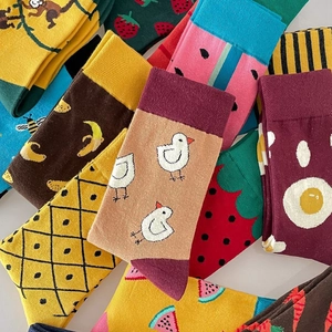 Colorful cotton crew socks with vibrant fruit and animal patterns like bananas and eggs