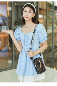 Crossbody phone bag in black PU leather with wide strap and gold crown tassel detail