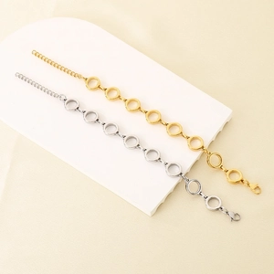 Detailed macro view of gold and silver interlocking rings on a stainless steel chain