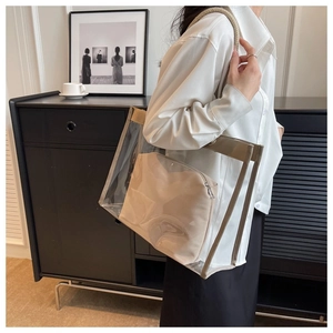 Detail of transparent PVC tote bag with beige inner pouch and braided rope handles