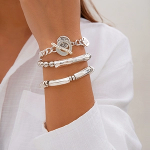Close-up of a 3-piece silver-tone beaded bracelet set with heart pendant and T-bar toggle clasp