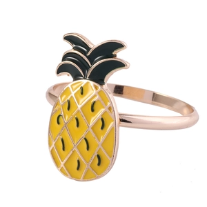 Detail of yellow and green enamel pineapple napkin ring in rose gold finish