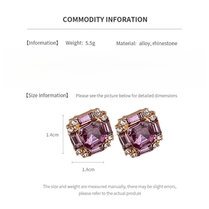 Detail view of gold square stud earrings with purple crystal and small rhinestones
