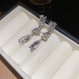 Detail view of silver drop earrings with marquise and pear shaped cubic zirconia