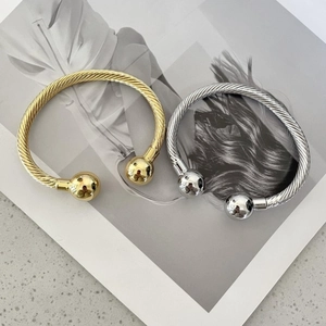 Classic twisted cable cuff bangle set in gold and silver finish with ball ends