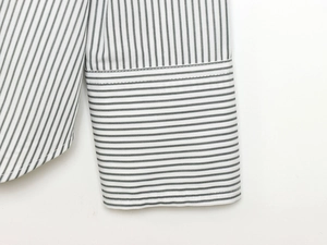 Close-up of long sleeve cuff on striped cotton poplin shirt with vertical patterns