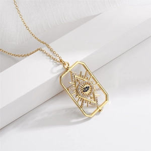 Detail shot of a gold devil eye pendant necklace with blue sapphire and micro zircons