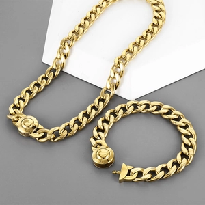 Detail of gold Cuban chain set with round magnetic clasp on minimalist geometric props