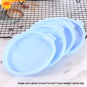 Detail view of light blue silicone cake lids with handles on marble surface