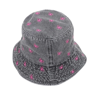 Detail view showing the texture and pink butterfly embroidery on a grey denim bucket hat.