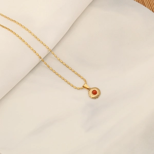 Macro view of vintage tiger eye stone heart necklace with handmade gold beads