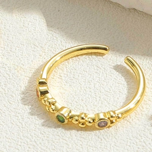 Macro shot of 14K gold-plated adjustable ring featuring colorful zircon stones and bead details