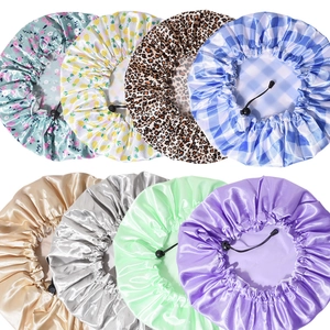 Multiple styles of adjustable satin shower caps with PEVA lining and elastic drawstrings