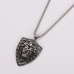 Macro view of vintage silver lion head shield pendant on a sturdy stainless steel chain