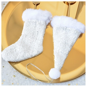 Detail of tweed white Christmas stocking and hat cutlery holder with faux fur trim