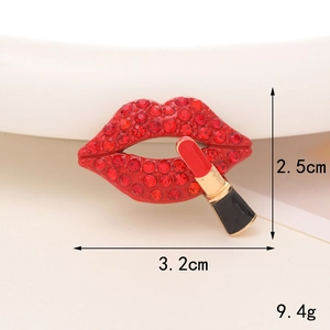 Detailed macro view of red rhinestone lip and lipstick brooch with precise dimensions