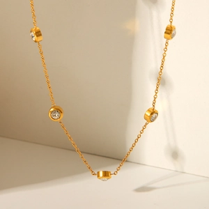 Detail of 18K gold plated stainless steel necklace with round clear zircon charms