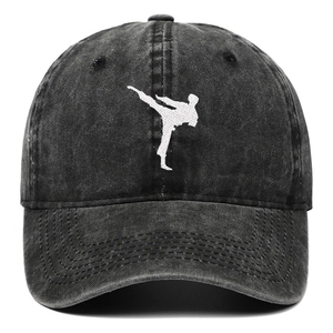 Vintage washed black denim baseball cap with martial arts embroidery on white background
