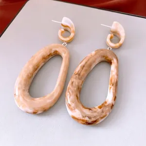 Retro acrylic oval drop earrings with amber marble texture and minimalist spiral design