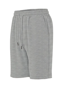 Detailed macro view of light gray waffle knit texture and drawstring waistband on shorts