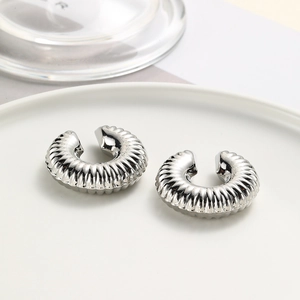 Pair of silver twisted spiral ear cuffs in a minimalist polished metal design