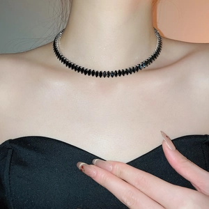 Detail view of a marquise cut black zircon choker necklace on a female model