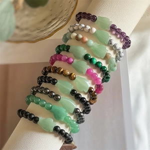 Detailed display of colorful natural agate and tiger eye stone beaded bracelets on display